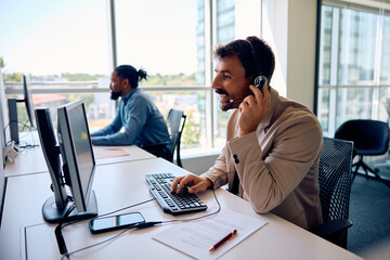 Wall Mural - Customer support representative working on desktop PC in office.