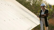 © wedmoments.stock - Female ecological engineer uses project documents and files and collects efficient information about solar panels. Photovoltaic solar farm. Green energy. Environment. Concept of green energy