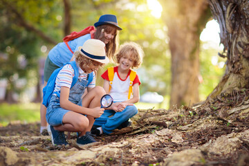 Kids explore nature. Children hike in sunny park.