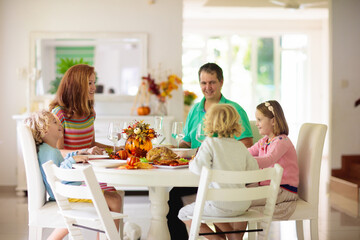 Wall Mural - Family with kids at Thanksgiving dinner. Turkey.