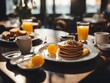 minimalist breakfast table with orange juice, pancake, egg etc. 