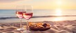 Beach picnic with wine snacks and glasses on sand outdoors