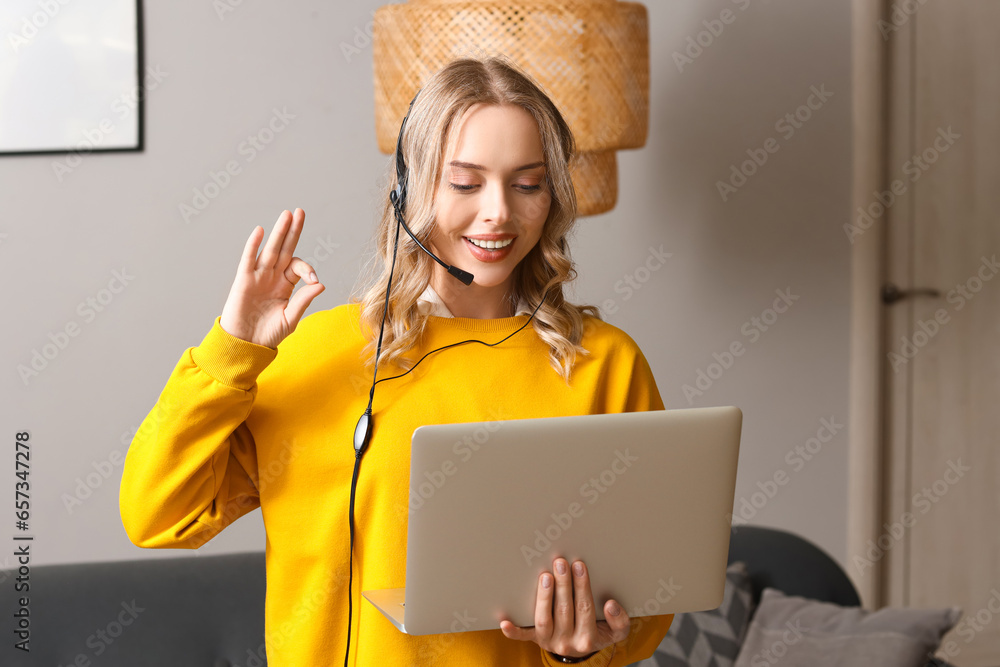 Female technical support agent with laptop working at home