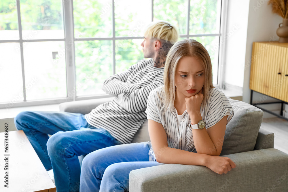Offended young woman with her boyfriend at home