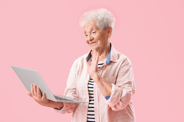 Sticker - Senior woman with laptop video chatting on pink background