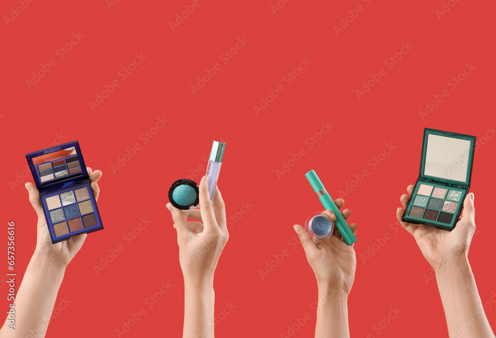 Women with makeup products on red background