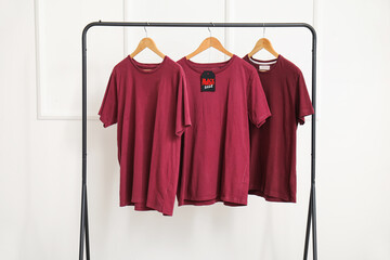 Wall Mural - Rack with t-shirts against light wall. Black Friday sale