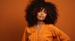 © MariaJos - African american female model, posing, orange clothing, Brazilian deep wave hair, unsplash, peach background