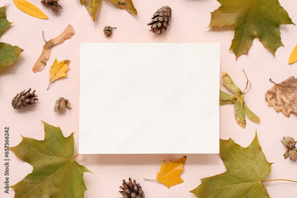 Beautiful autumn composition with leaves, pine cones and blank card on pink background
