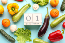 Fresh Vegetables, Fruits And Cube Calendar With Date NOVEMBER 1 On Blue Background. World Vegan Day Concept