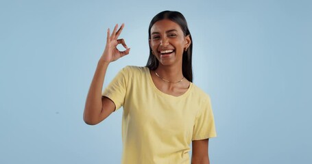 Wall Mural - Okay sign, face and woman in studio for vote, certified review or feedback on blue background. Portrait, happy indian model and ok for success, agreement and icon of support, yes emoji and excellence