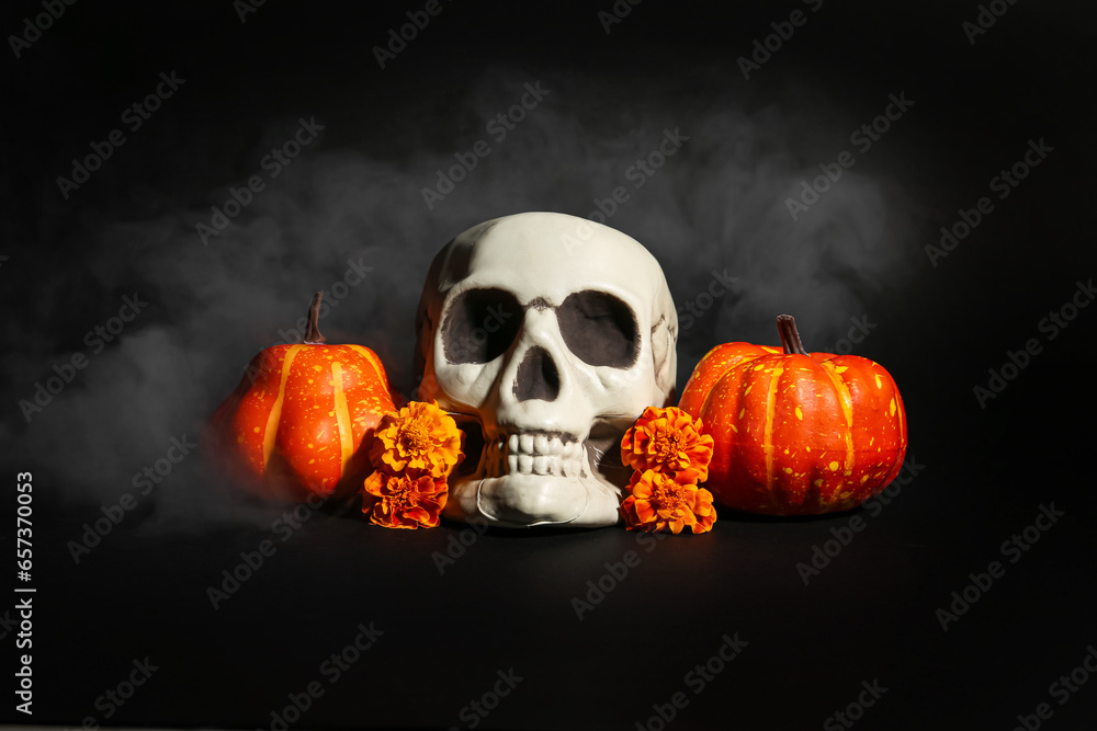 Halloween skull with pumpkins and marigold flowers on black background