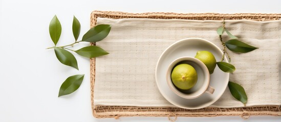 Wall Mural - Natural linen tea towel or napkin on wicker tray in flatlay on white background