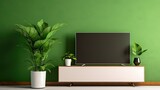 Fototapeta  - Modern TV cabinet on a plain green wall in the living room