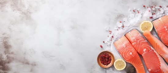 Wall Mural - Salted and peppered raw salmon prepared for cooking isolated pastel background Copy space