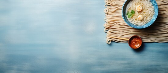 Poster - Ramen noodles on a bamboo mat with chopsticks isolated pastel background Copy space