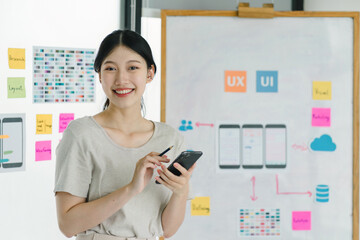 Wall Mural - portrait of creative ux ui designer working on screens for mobile responsive website development, fo