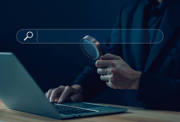 Wall Mural - businessman using a laptop, show search bar. concept of a website to find a job and career on the in