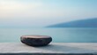 A mockup product display background featuring a stunning ocean backdrop. The product mockup is set on a dark, flat stone podium.
