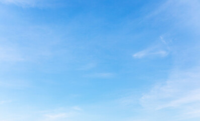 Wall Mural - blue sky background and white clouds soft focus, and copy space horizontal shape.