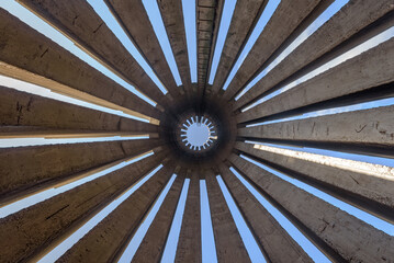 Abstract photo in a bottom view of a concrete monument with several pillars scattered in a circular pattern