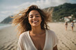 A woman embraces the beauty of the beach and the freedom of the open air with  a joyful smile and a sense of pure bliss.