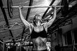 © IvSky - The woman bodibilder raises the barbell in the gym.
