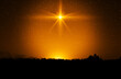 Christmas star. Background of the beautiful nite golden starry sky and bright star. Concept Nativity of Jesus Christ