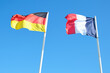 Germany and France flag waving in the wind against blue sky together . international diplomacy concept