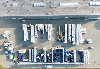 Sticker - Aerial view of warehouse storages or industrial factory or logistics center from above. Top view of industrial buildings and trucks