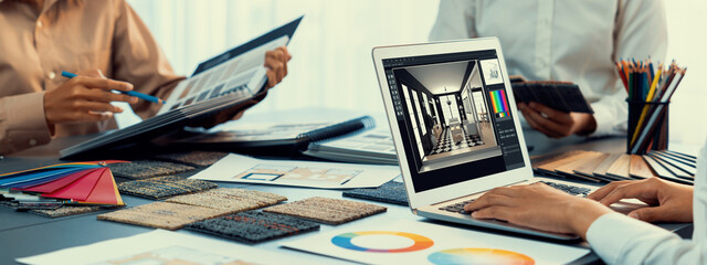 Group of interior architect designer team at table choosing color samples with architecture software on laptop screen. Modern house renovation and interior color selection design concept. Insight