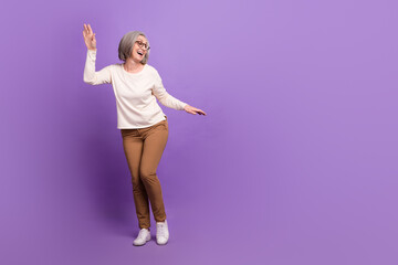 Wall Mural - Full length portrait of charming senior lady dancing youth party feel young wear smart casual outfit isolated purple color background