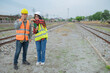 © reewungjunerr - Two engineer working at train station,Work together happily,Help each other analyze the problem,Consult about development guidelines