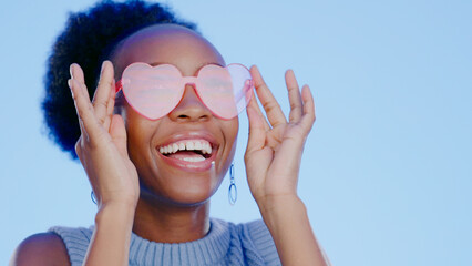 Canvas Print - Fashion, sunglasses and smile, black woman in studio with cool, trendy summer style and creative mockup. Happiness, luxury eyewear and excited, fun model with designer frame on blue background space