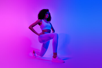 Sticker - Full body profile portrait of focused slender figure lady doing lunges trendy outfit isolated on colorful neon background