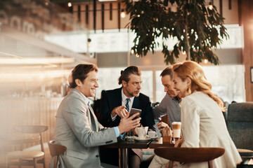 Wall Mural - Diverse group of business friends having coffee after work in a café decorated for Christmas and the new year holidays