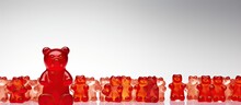 Distinctively Colored Red Gummy Bear Stands Out Among Others Symbolizing Diversity