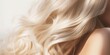 Beautiful, Weatherproof Blond Hair: A Close-Up of Wavy Locks on a White Surface, Showcasing Shampoo's Effect on Volume, Strength, and Beauty
