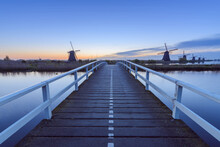 Wooden Bridge With Windmills At Dawn, Kinderdijk, South Holland, Netherlands