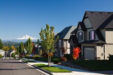 Oregon, United States Of America; Autumn Colors Along A Street With New Homes And A View Of Mount Hood