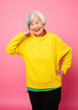 © Julia Zarubina - Generative AI, joyful asian korean elderly woman in casual stylish clothes smiling on color background, advanced age, old lady, space for text, mature people, happy pensioner, retired lifestyle
