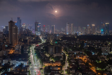 Wall Mural - Full moon over night Tel Aviv skyline