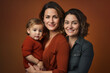 © MariaJos - two female parents with their son. solid color background. lesbian. family. lgtb.