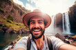Handsome tourist visiting national park taking selfie picture in front of waterfall - Traveling life style concept with happy man wearing hat and sunglasses enjoying freedom in the nature