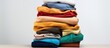 © AkuAku - Piles of clothes alone on white