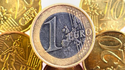 Wall Mural - Panning on a One Euro Coin. Close-Up slow moving slider shot. Business and financial for saving or the investment background concept. Freshly minted moneys Macro shooting
