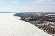 Enjoy a mesmerizing drone view of Oro-Medonte, Port Severn, Midland, Victoria Harbour, Sturgeon Bay, Robins Point, Port McNicoll, and a frozen lake on a foggy winter day. The misty landscape creates a