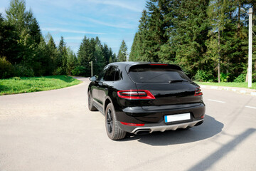 Picturesque view of modern black car on asphalt road outdoors