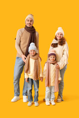 Poster - Happy family in winter clothes on yellow background