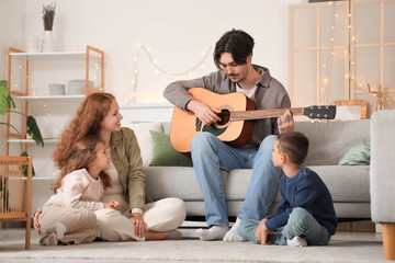 Poster - Happy family playing guitar at home